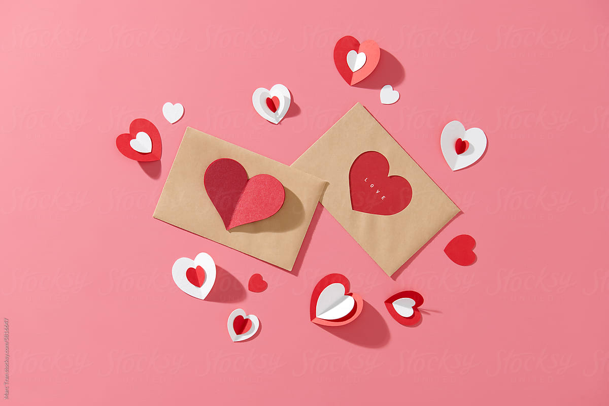 Love letter envelope with paper craft hearts - flat lay