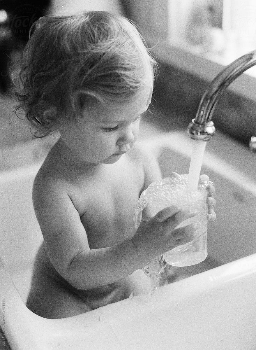 baby taking bath in sink