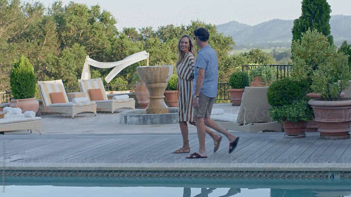 Couple Walking By Pool At Luxury Resort By Stocksy Contributor Trinette Reed Stocksy 1193