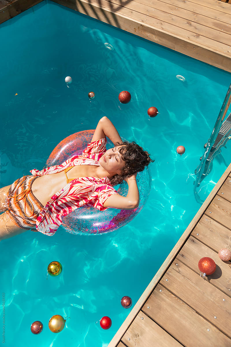 Woman lying on ring in pool