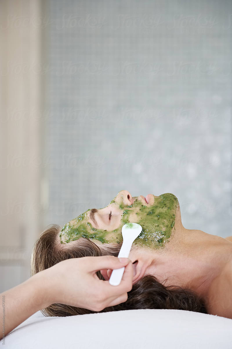 Man receiving an all natural green facial at luxury spa