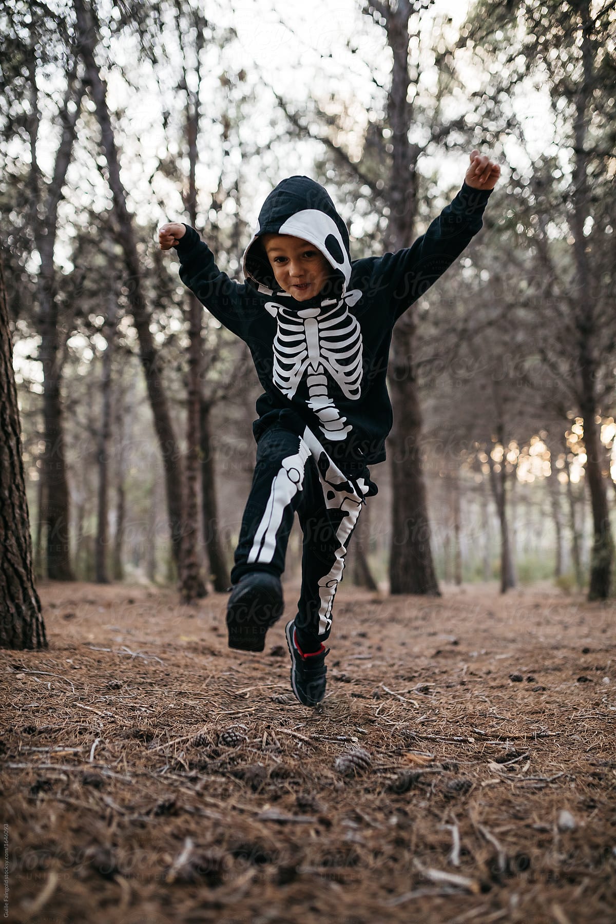 Boy in halloween costume in forest.