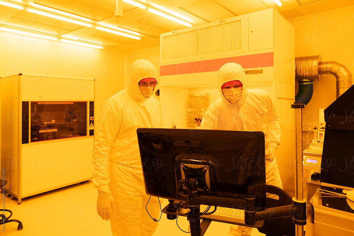 Researchers Working With Computer At Clean Room