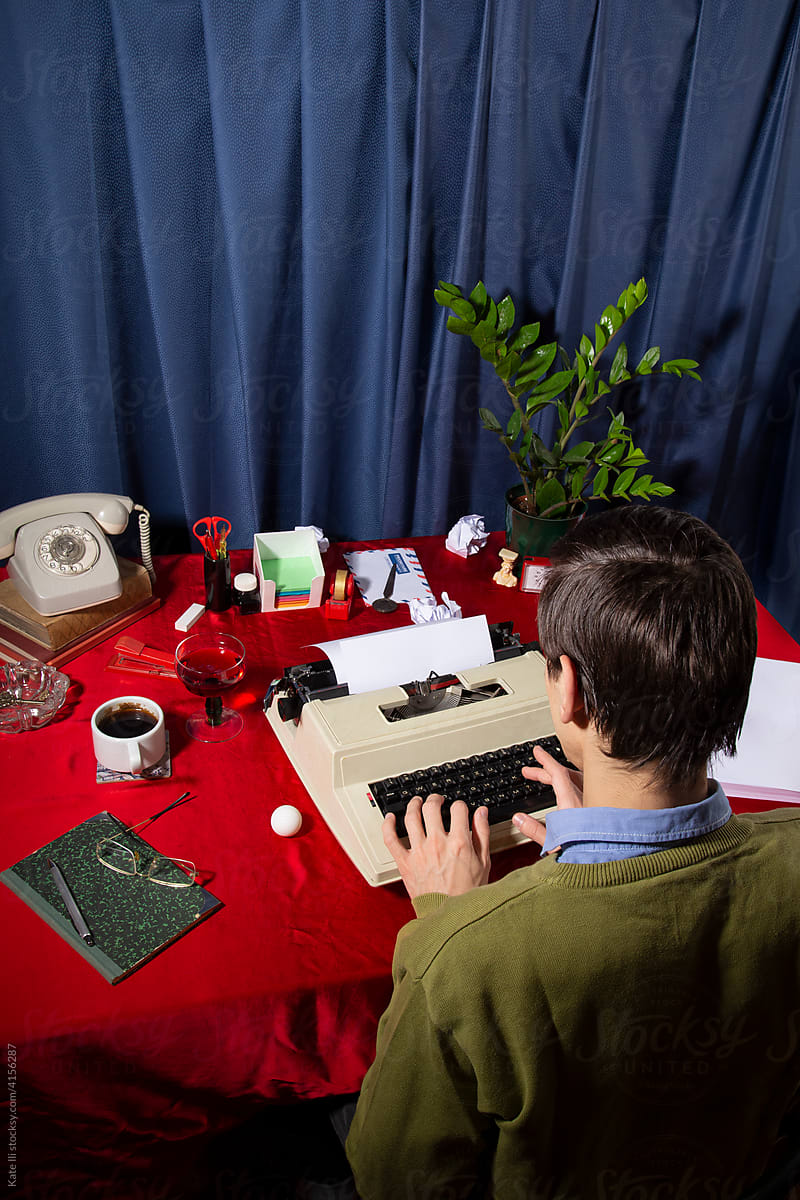 Office worker typing on typewriter