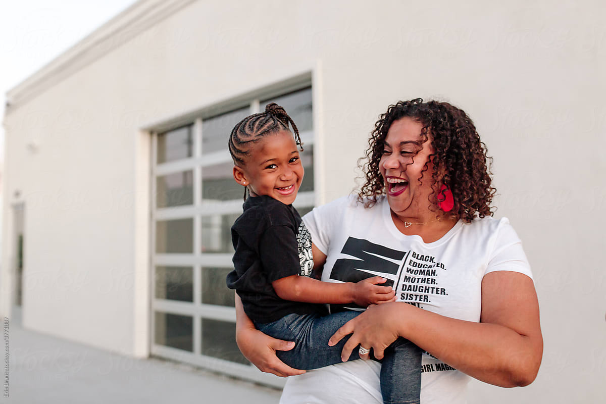 Happy Black mom with young daughter