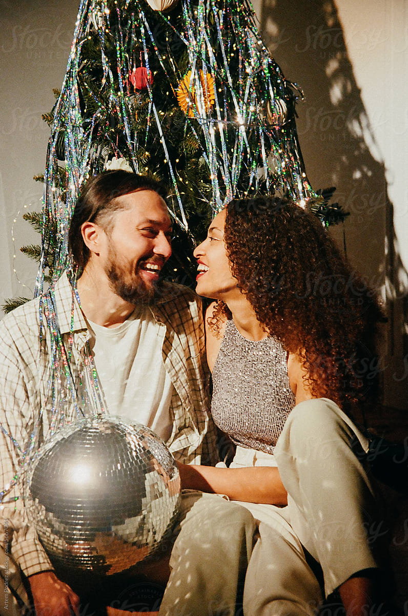 Christmas date portrait of lovers near a decorated Christmas tree