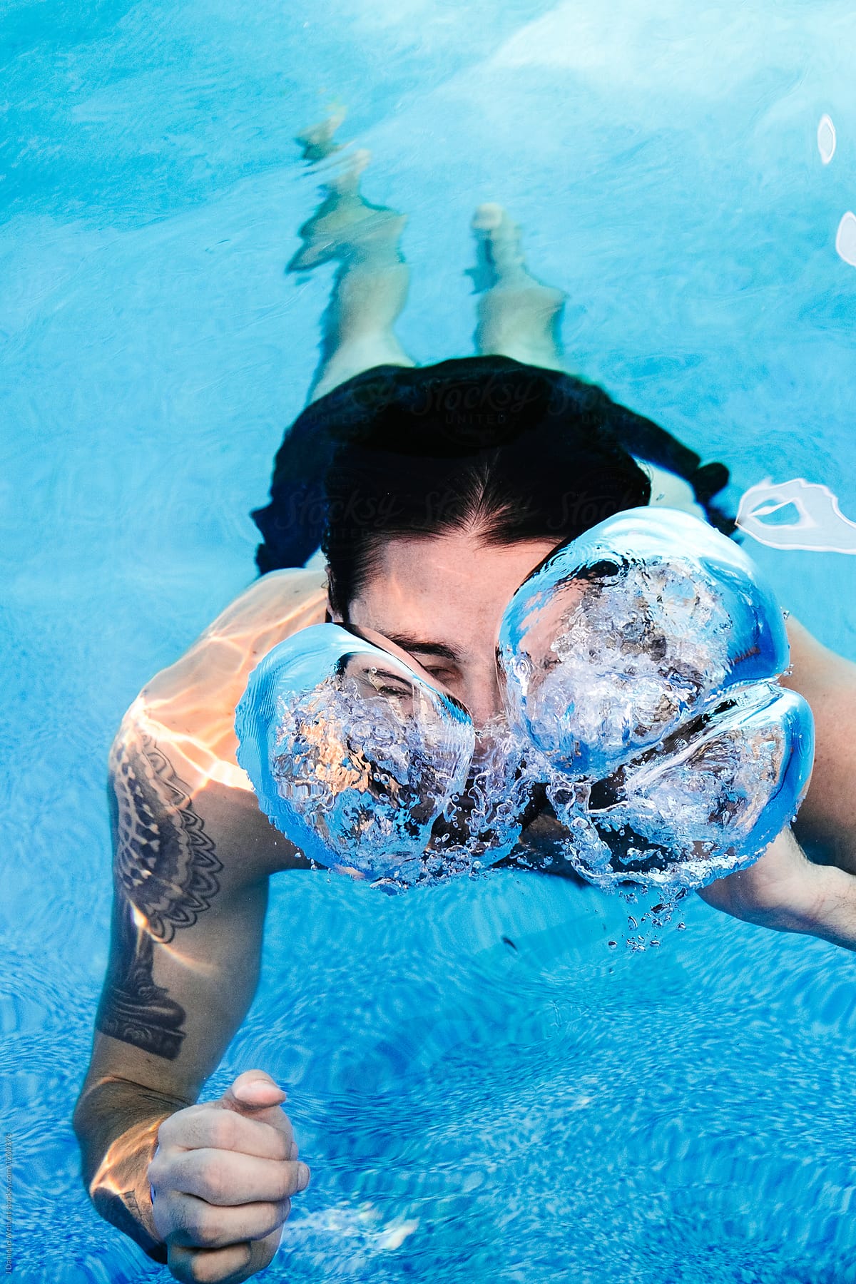 A Caucasian Man Swimming Underwater In A Pool Del Colaborador De