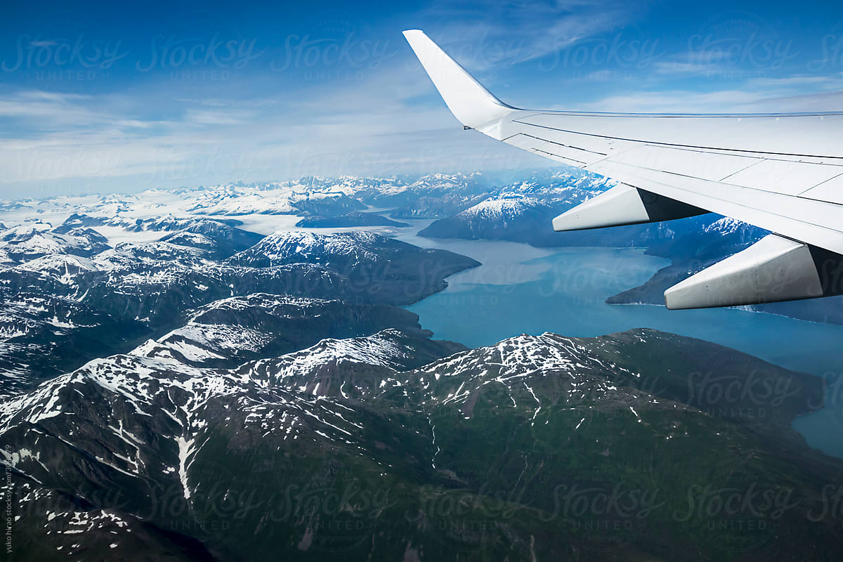 Airplane window view over a glacier fjord in Alaska
