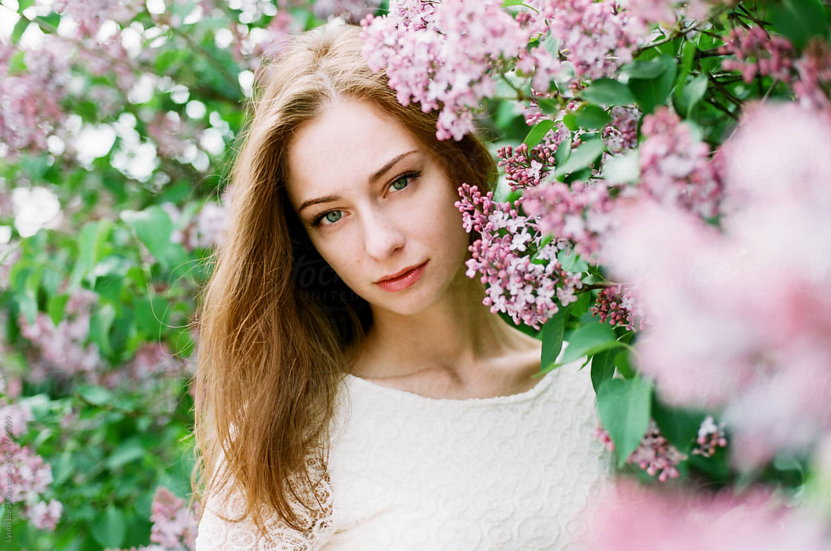 Portrait Of Redhead Woman Among Pink Lilac Del Colaborador De Stocksy Amor Burakova Stocksy 7517