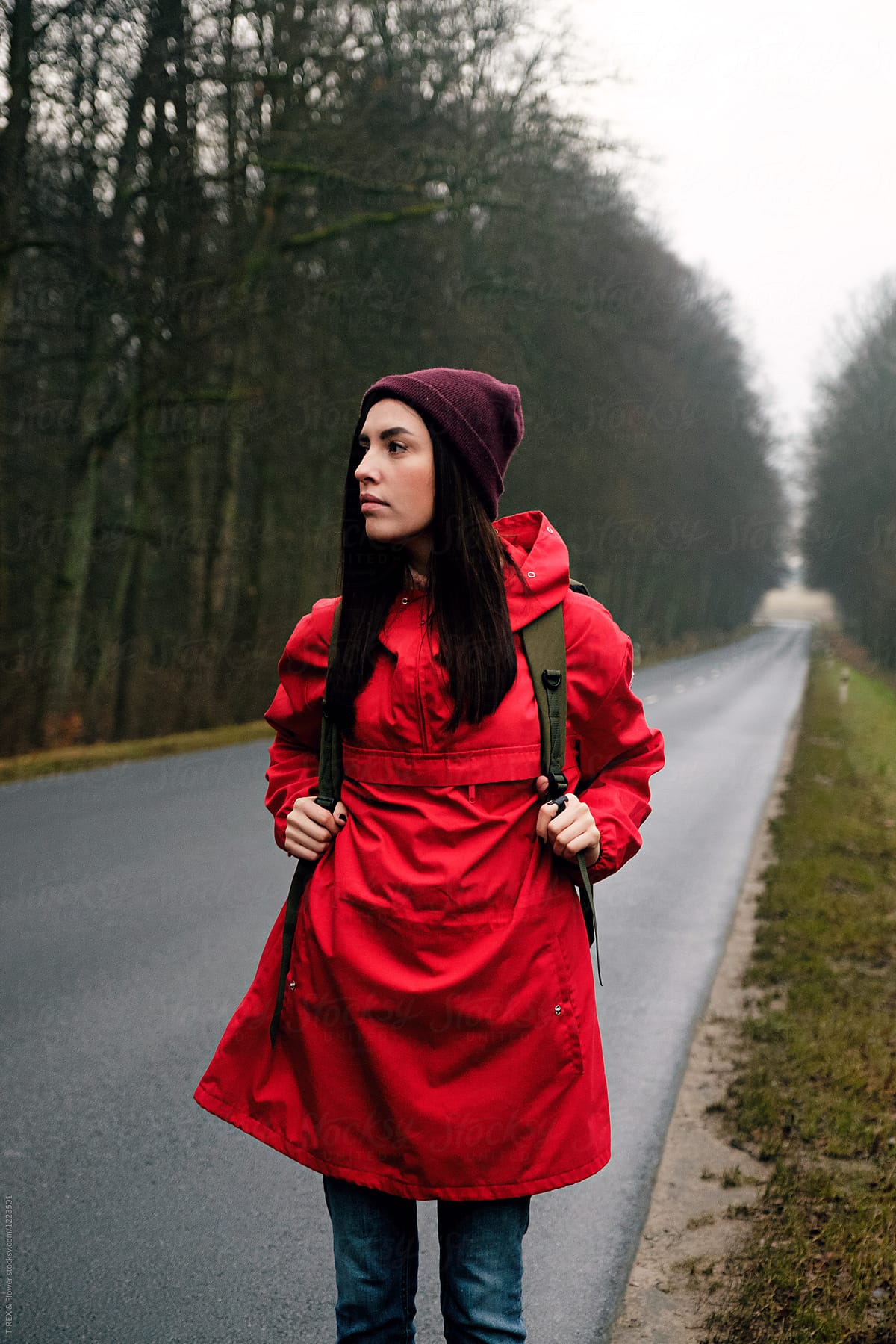 Woman with backpack on empty road
