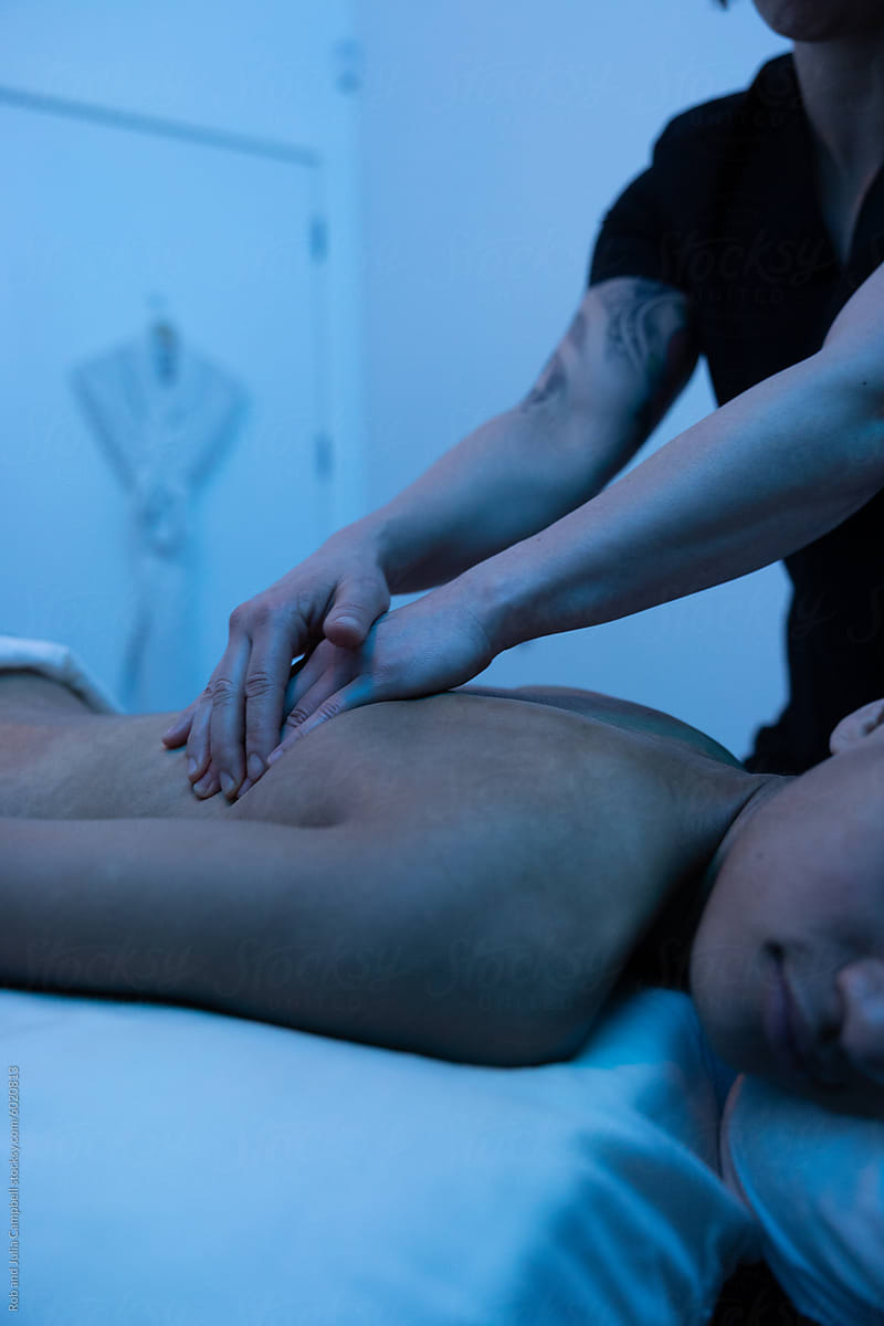 Massage therapist working on client\'s arm