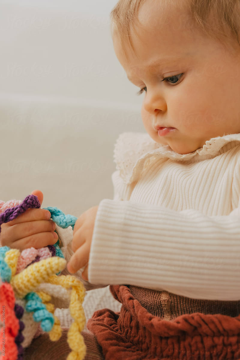 Baby focused on toy