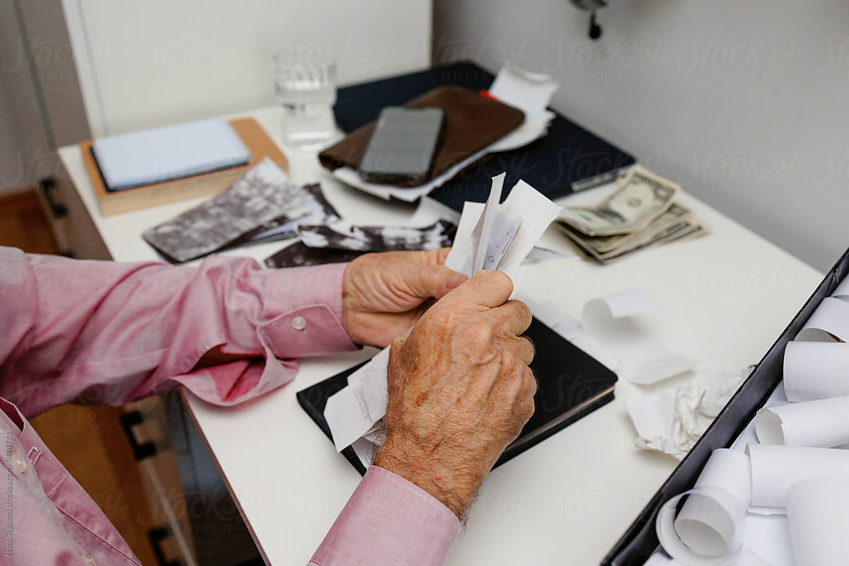Men's hands working with checks and receipts