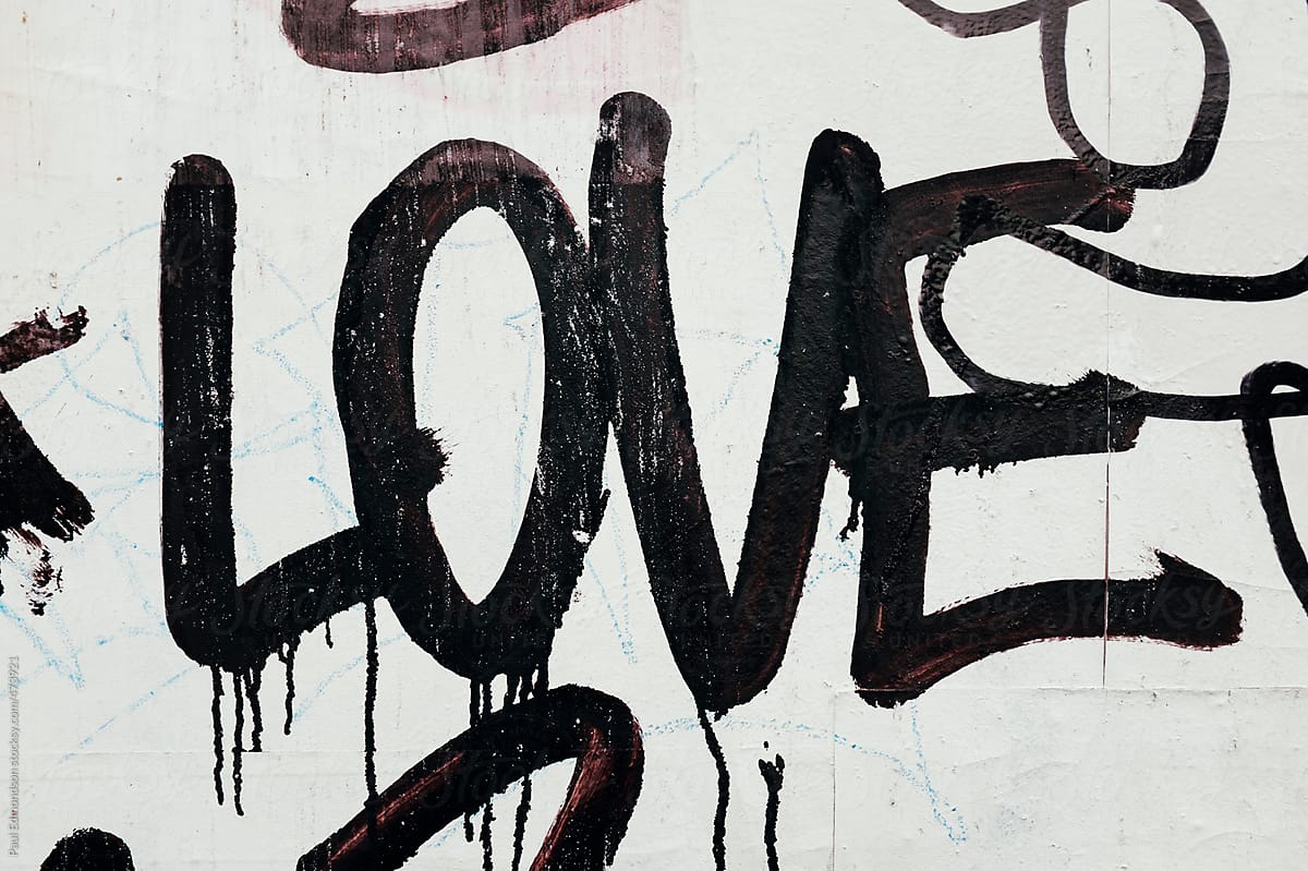 The word LOVE painted on exterior of building wall, close up