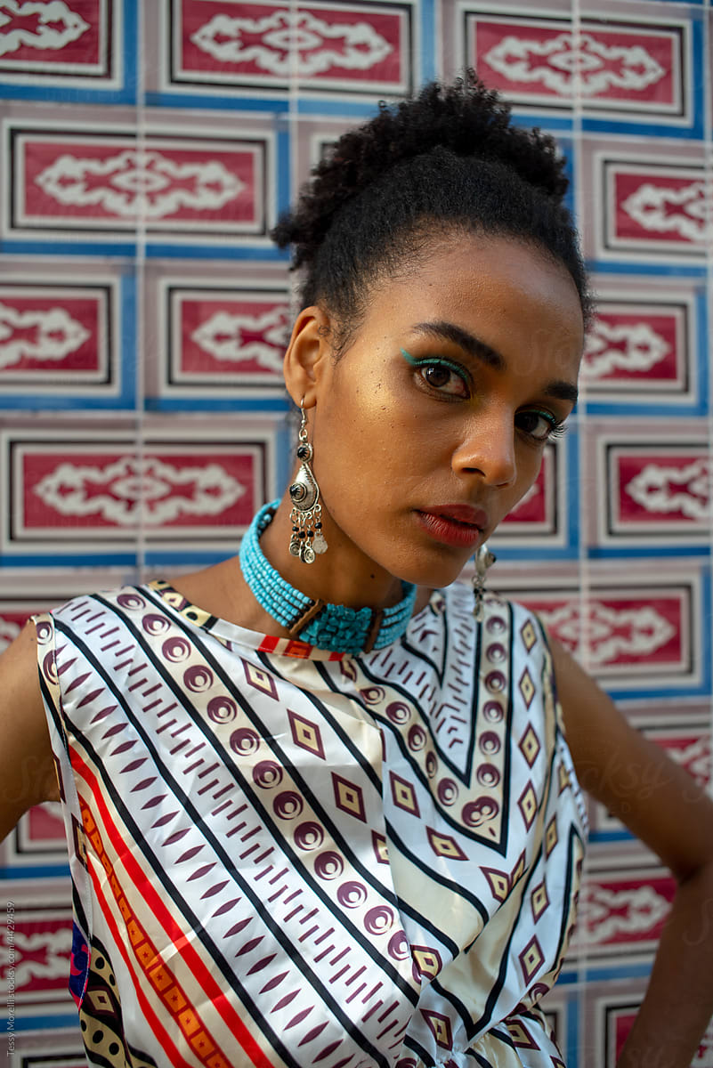 Millennial African modern woman portrait in African print silk dress