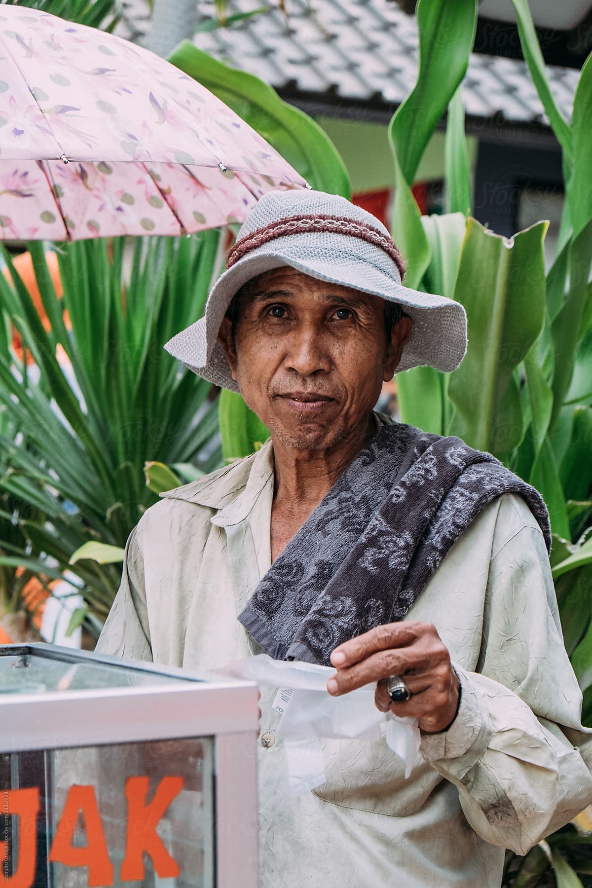 Indonesian Old Man Preparing And Selling Typical Food On The Street Del Colaborador De Stocksy