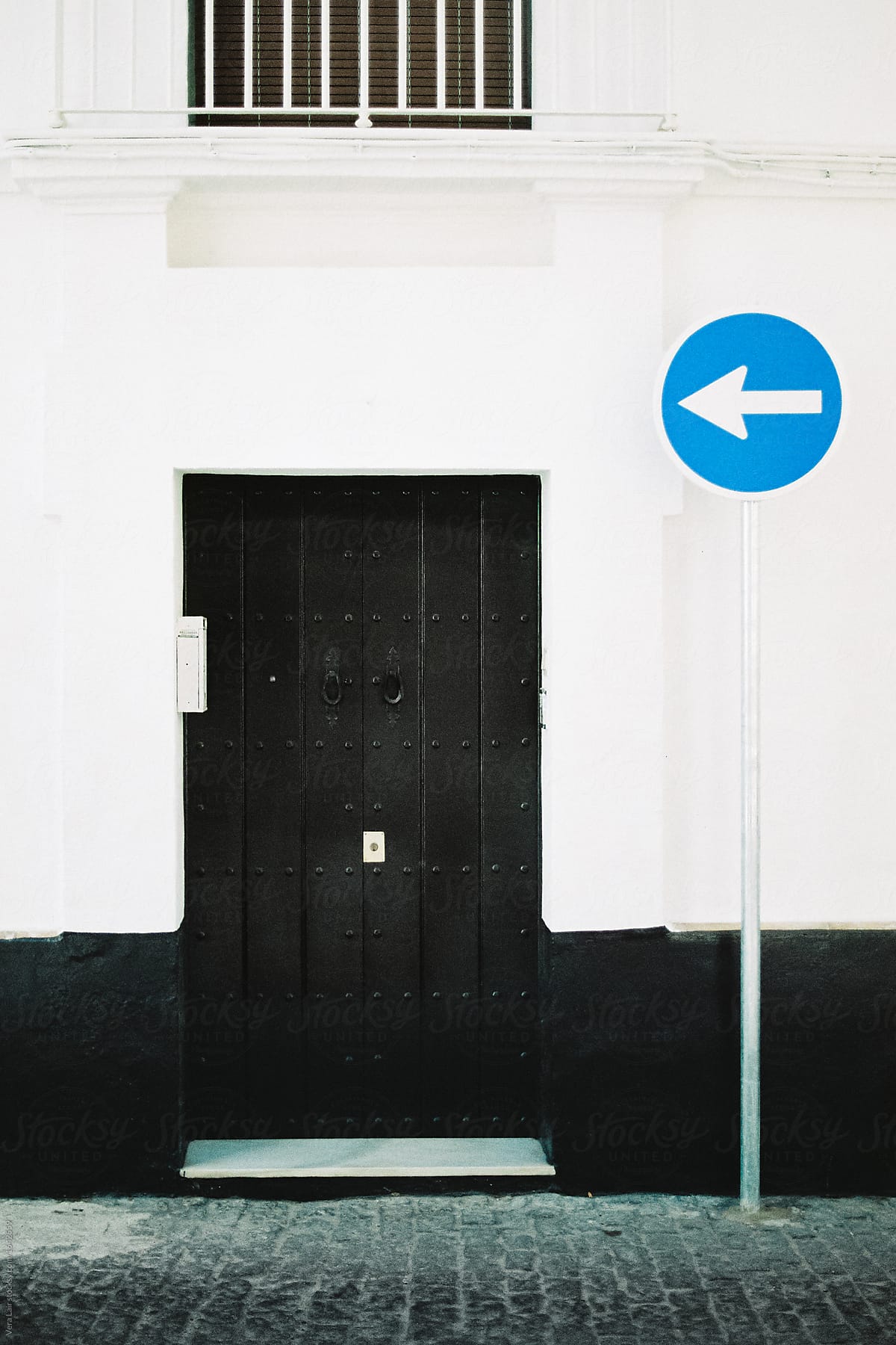 Black door and direction arrow