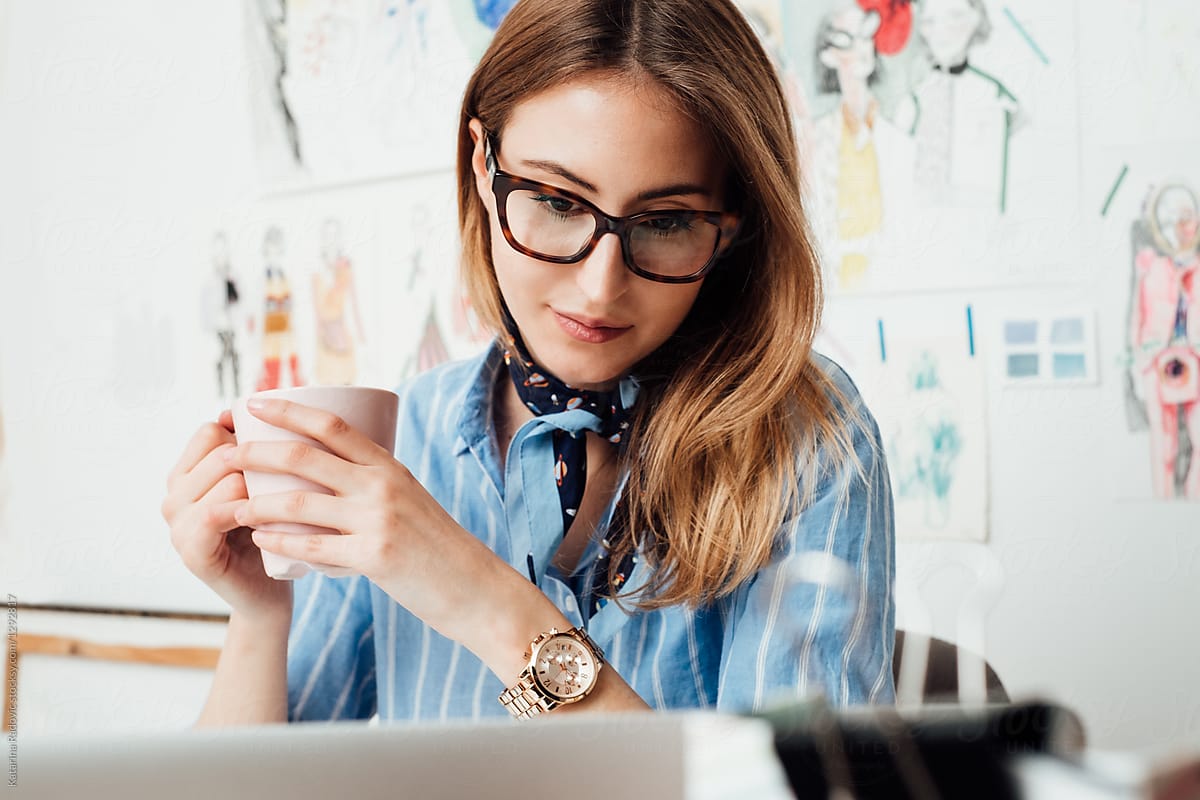 Young Woman With Glasses Looking At Compiuter By Stocksy Contributor