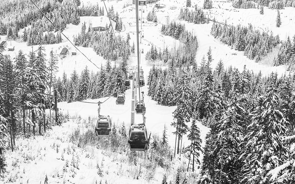 Cable car ride high atop the trees and mountains covered with snow