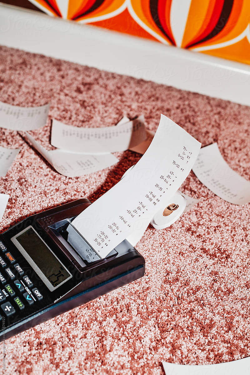 calculator and pieces of paper with calculations