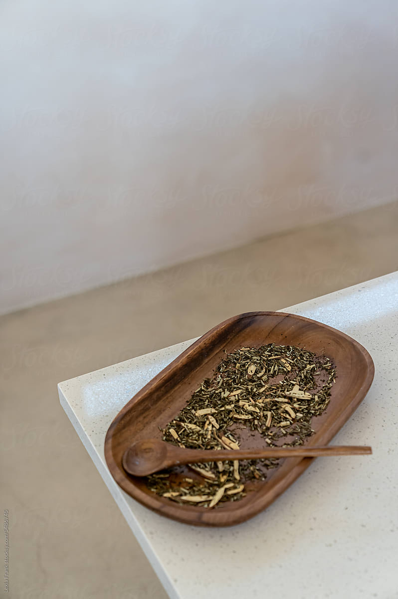 organic tea leaves on wood platter