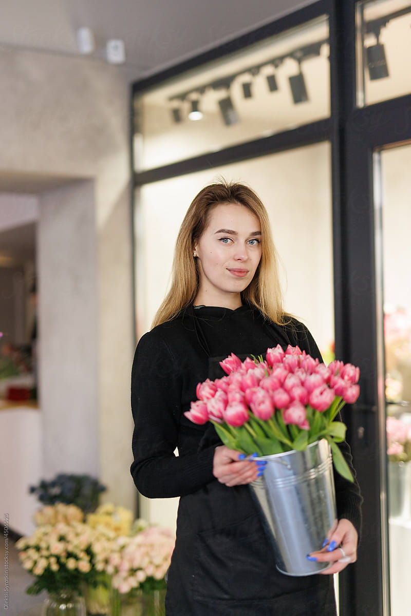 Skilled florist working in modern flower shop