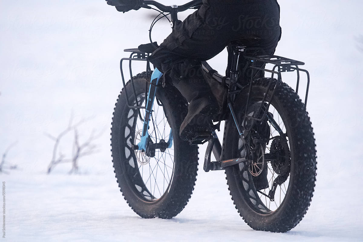 Woman riding a fatbike on a snow covered slope