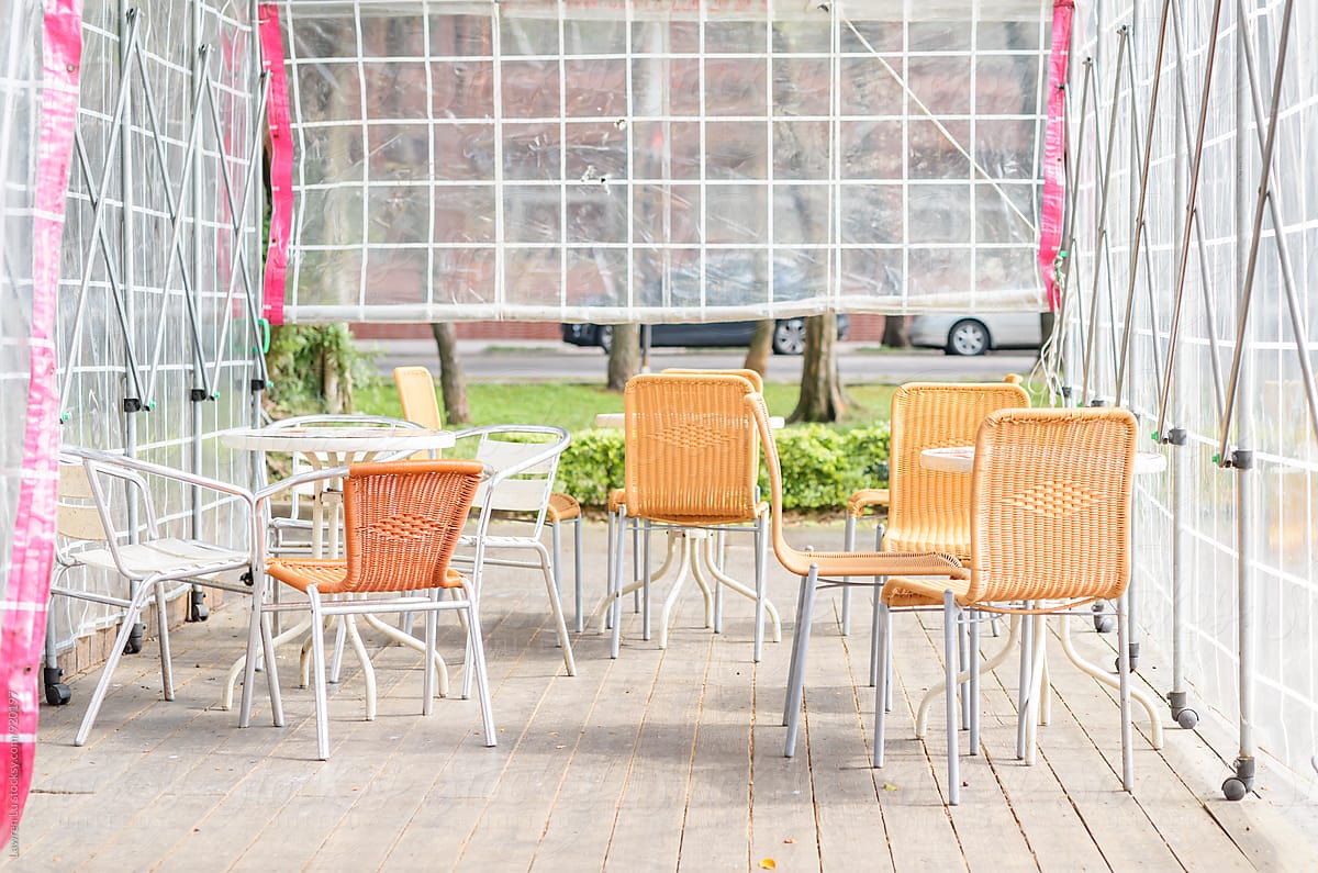 Table and chair of outdoor cafe under clear canopy