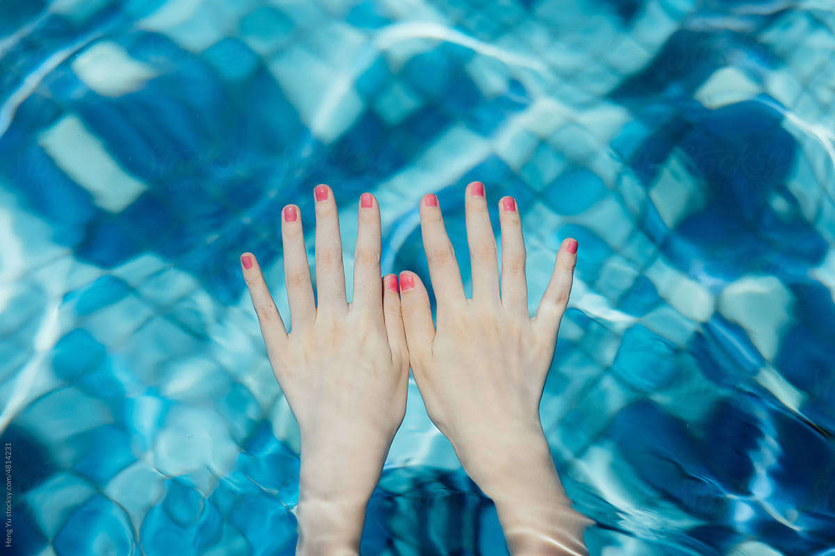 Woman hands in swimming pool
