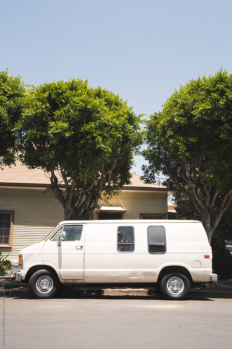 Vintage White Van Parked in Front of Green Trees in Los Angeles Neighborhood