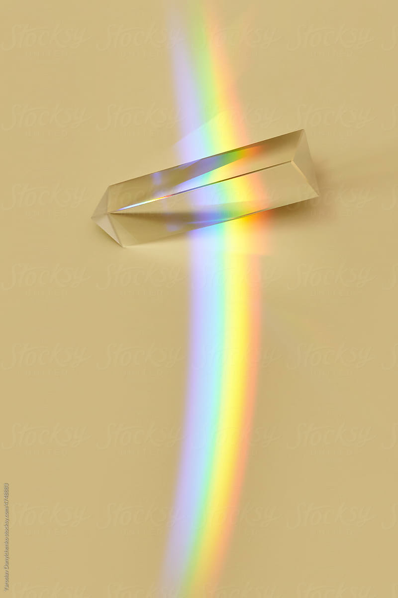 Glass triangular prism with rainbow.