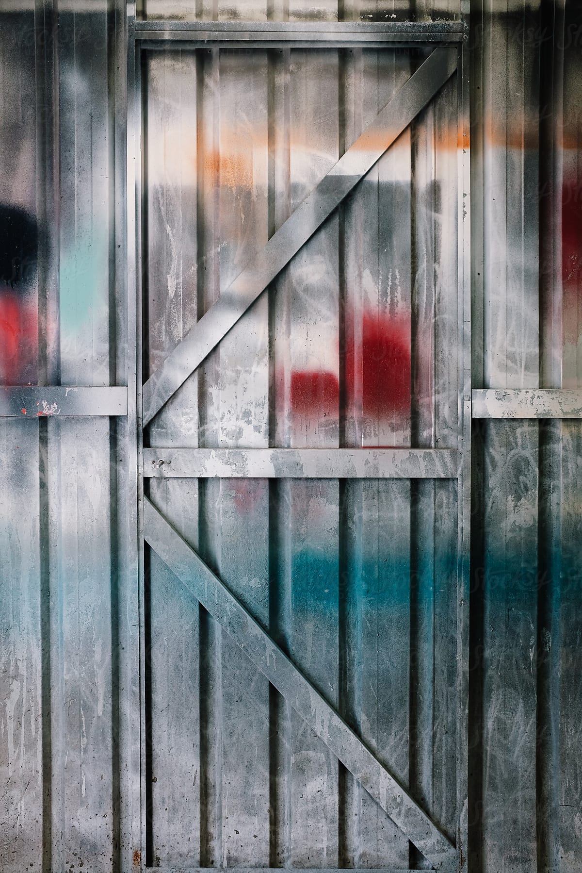 Colourful spray painted door inside paint shed