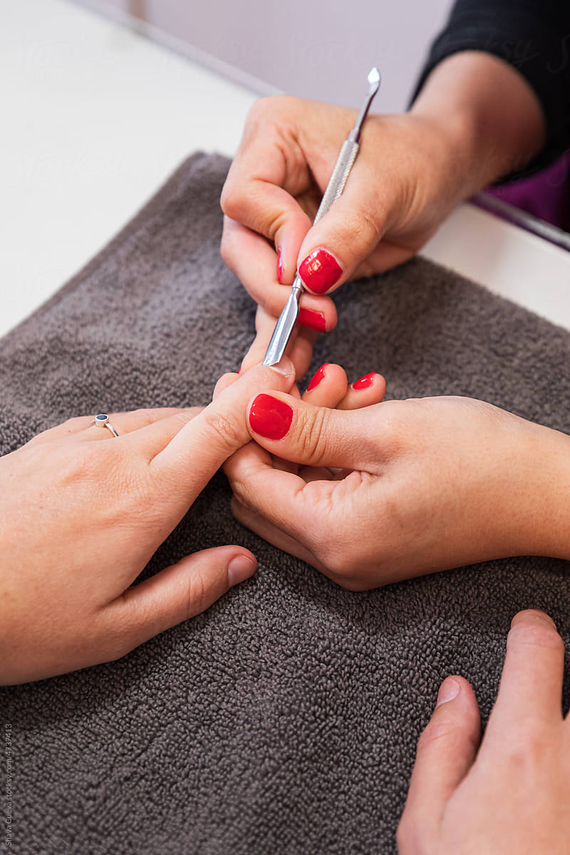Manicurist using a tool for polish nails