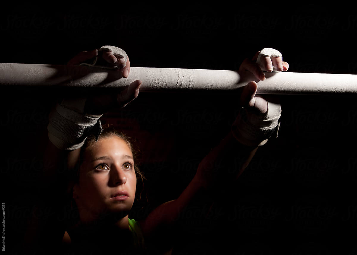 Trepidation: Look of Concentration as Gymnast Addresses Bars