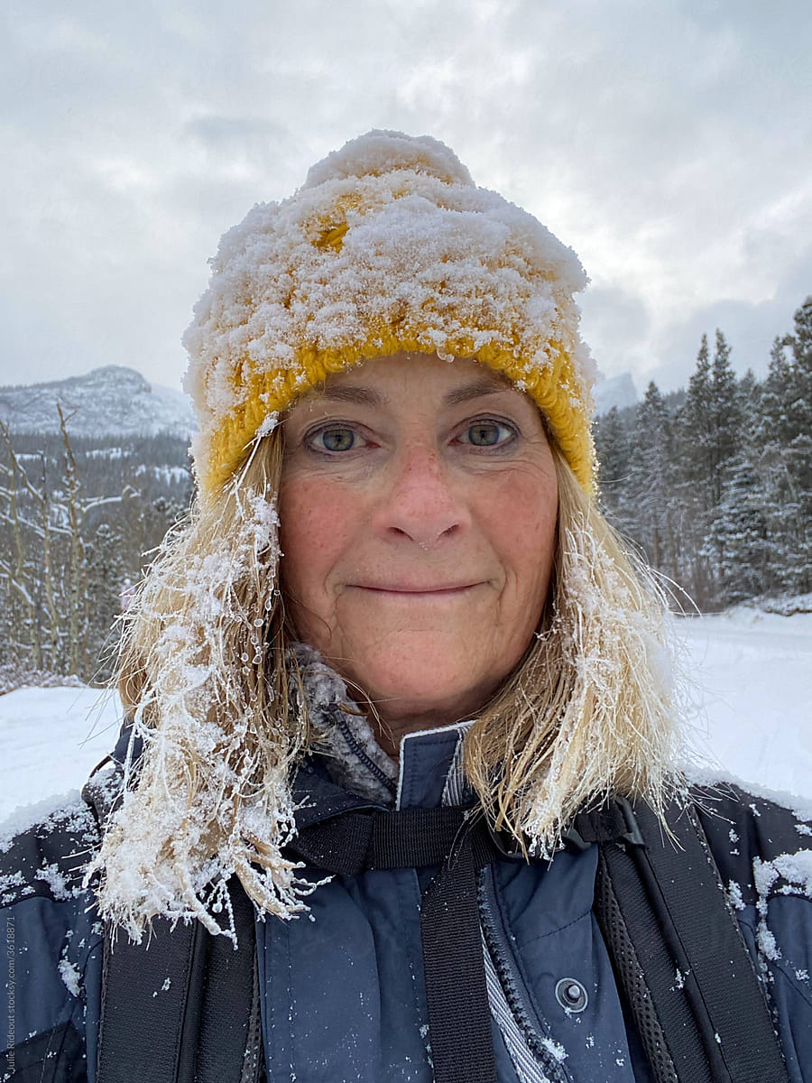 Senior woman selfie after a snowy hike in the mountains