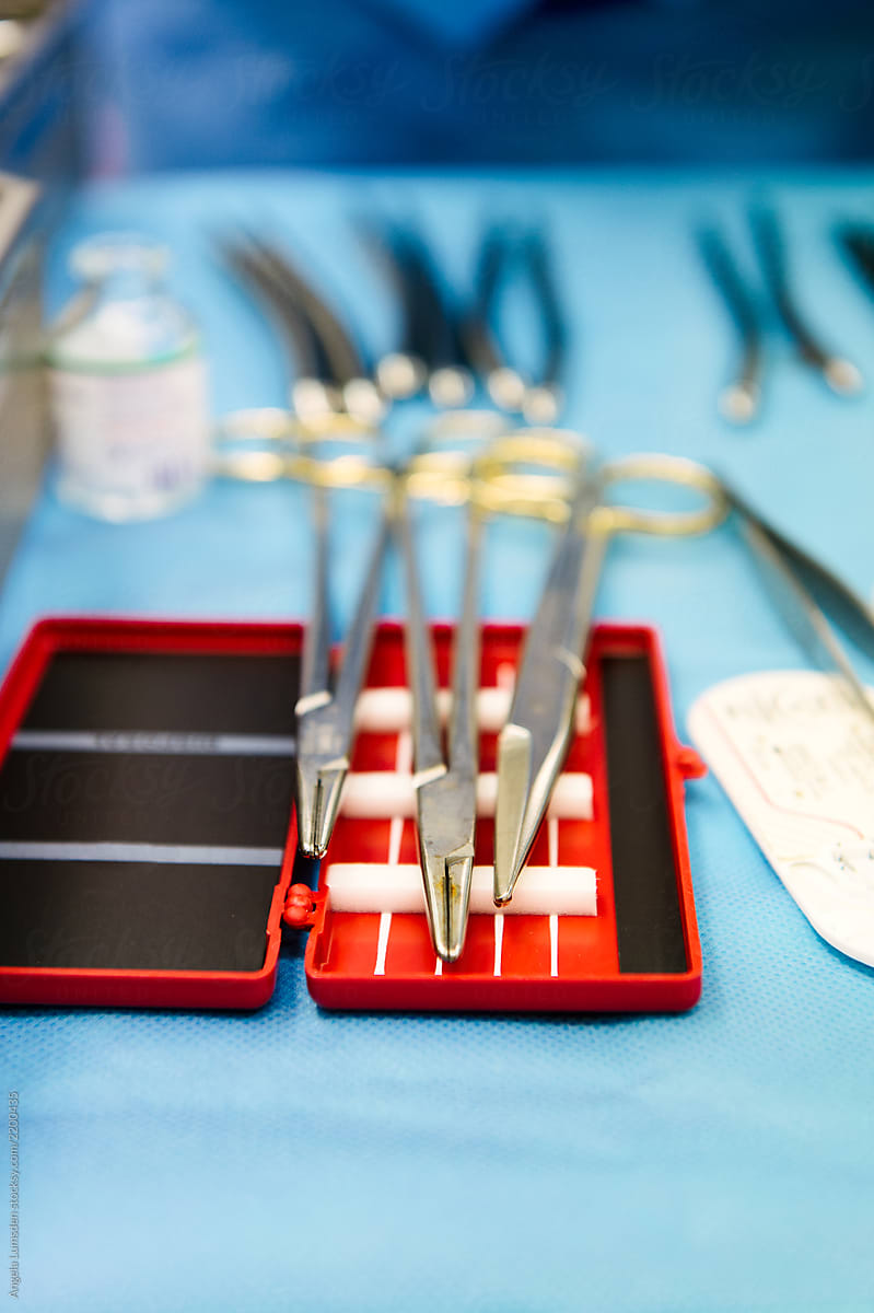 Needle holders and scissors ready for suturing on a sterile tray