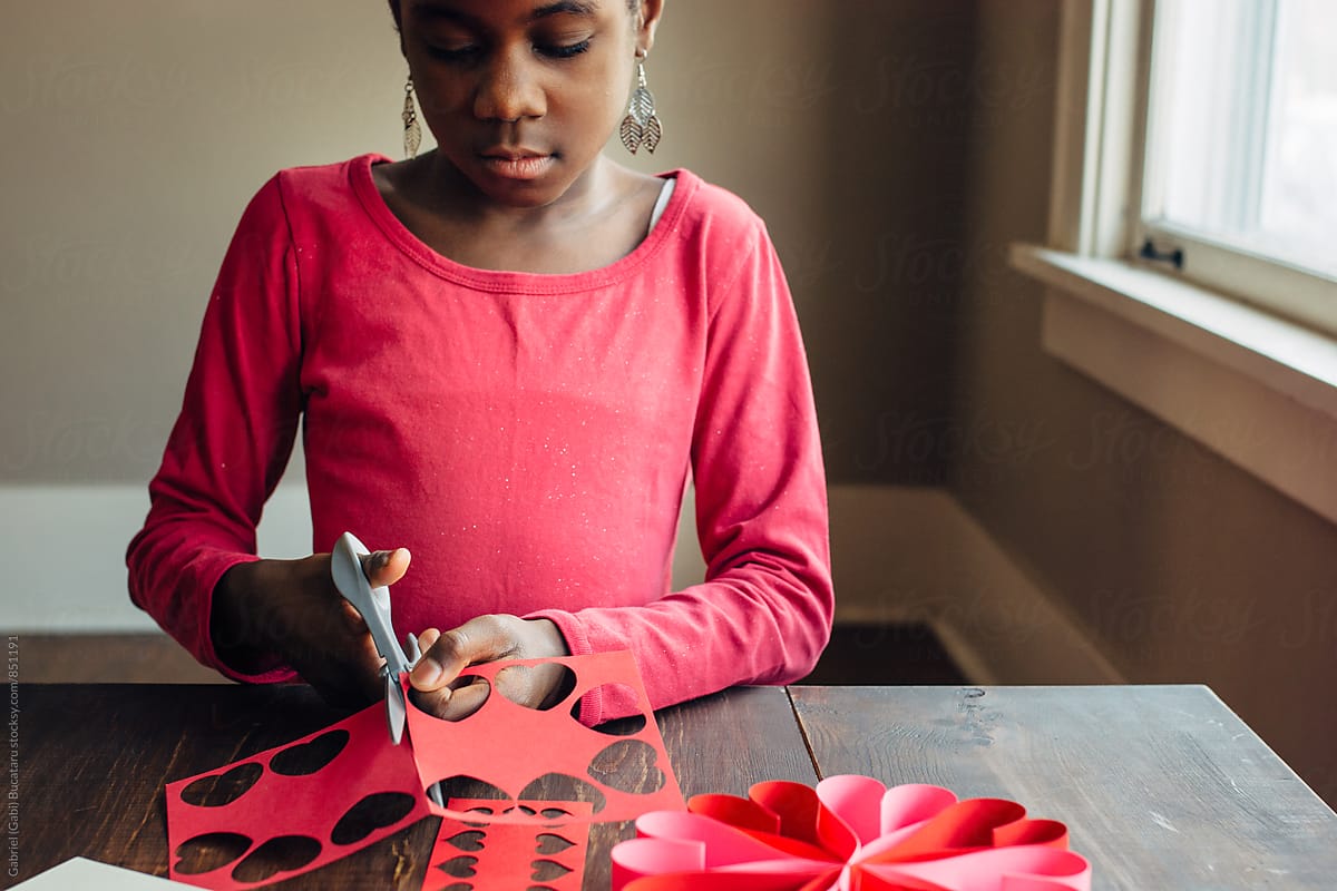 African American girl working on Valentines crafts