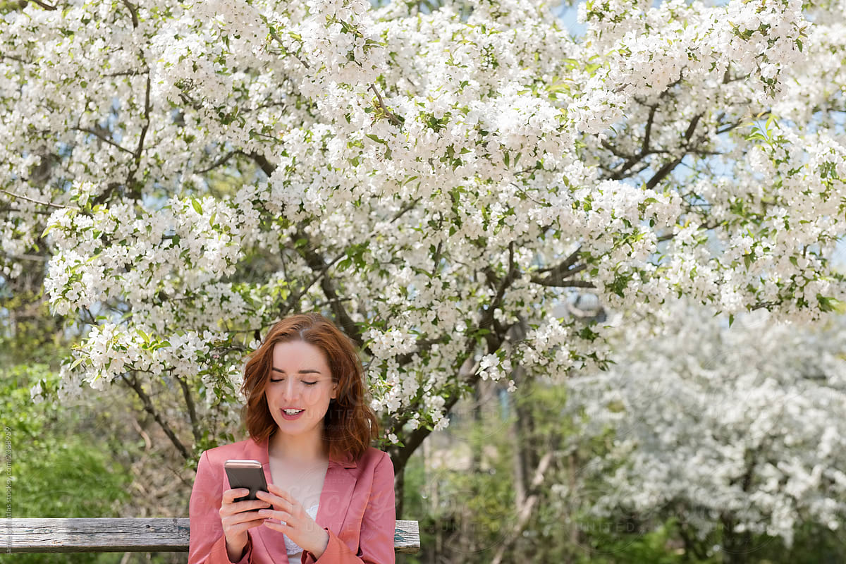 Woman in park looking at phone