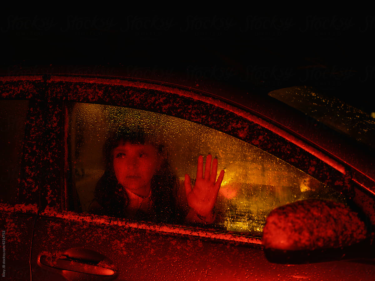 Woman passenger holds her hand on the window.