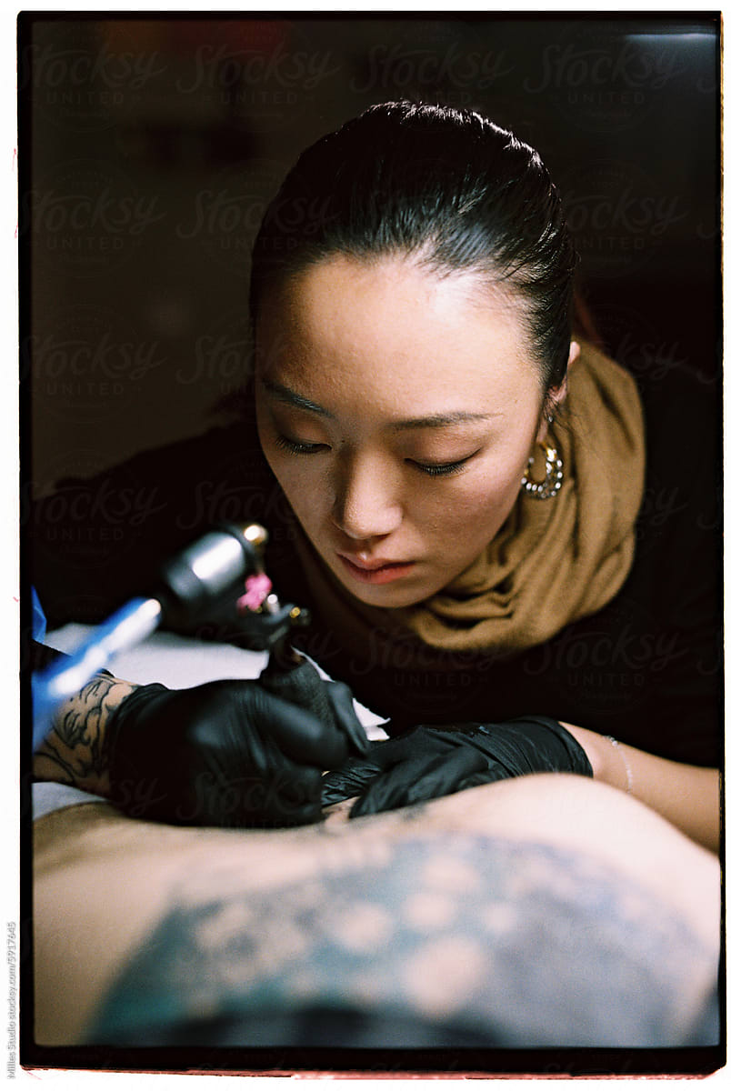 Beautiful tattoo artist working