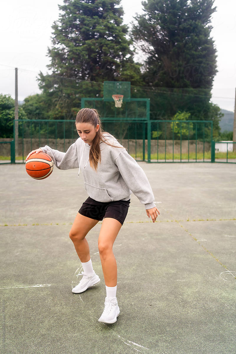 Sport Girl Playing Basket Outdoors.