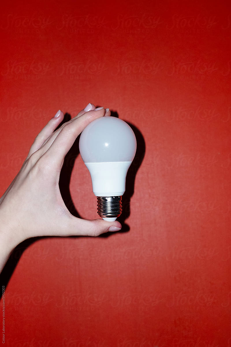 Hand holding  light bulb representing new idea, ideation, eureka