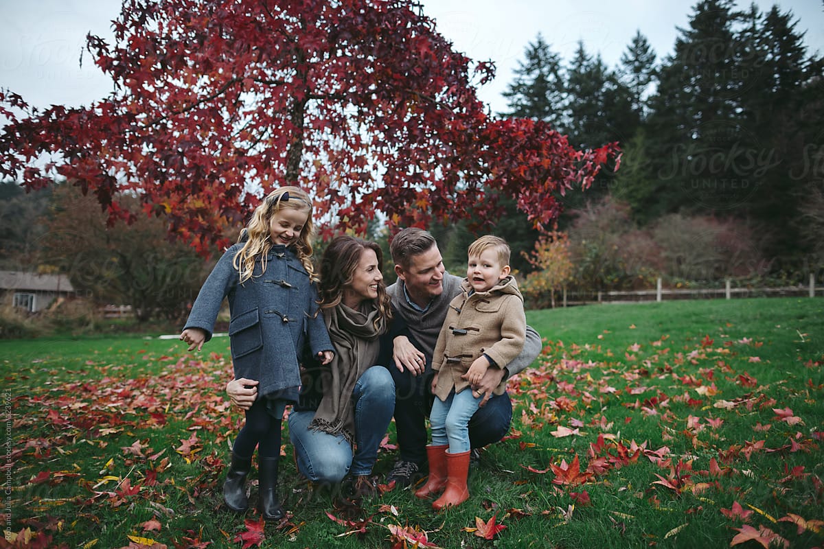 Happy family outside in colorful fall backyard