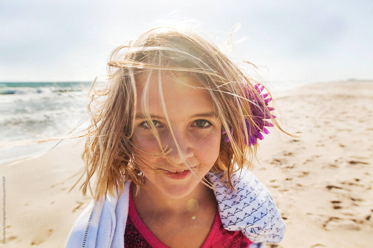 Wide Angle Headshot Of Pre Teen Girl On Beach With Wind In Hair By Dina