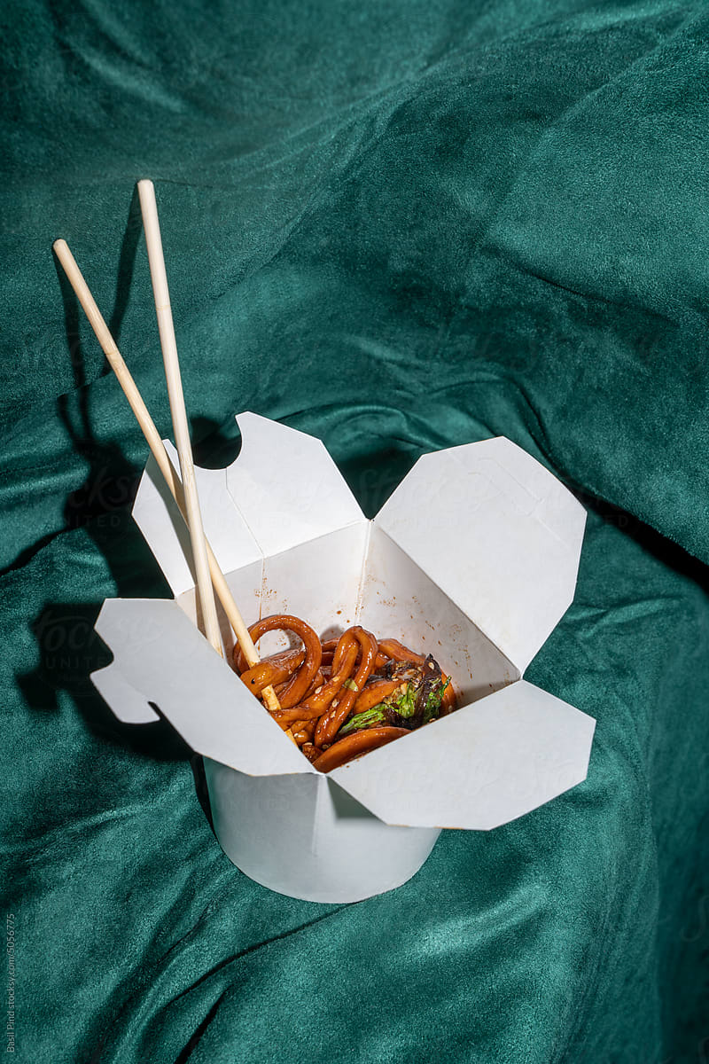 Asian noodle udon in dish on green