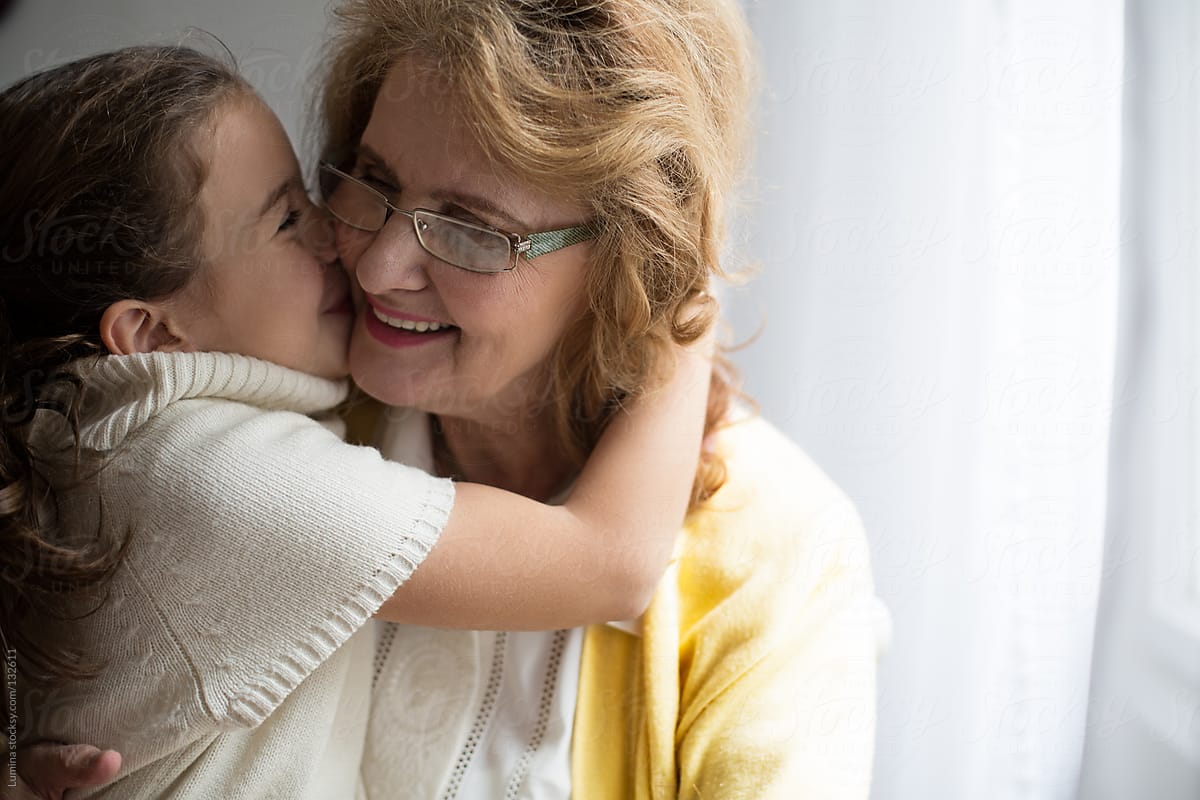 Girl Kissing Her Grandmother By Stocksy Contributor Lumina Stocksy