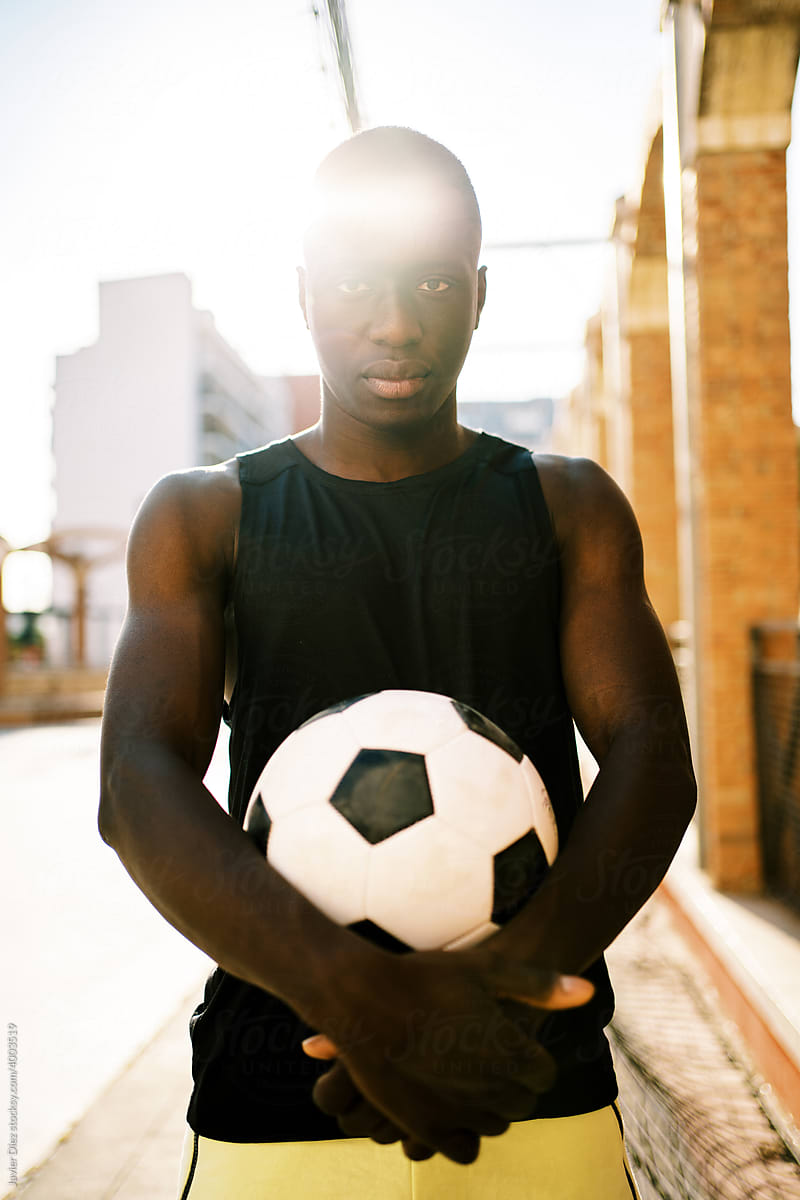 Black football player on street