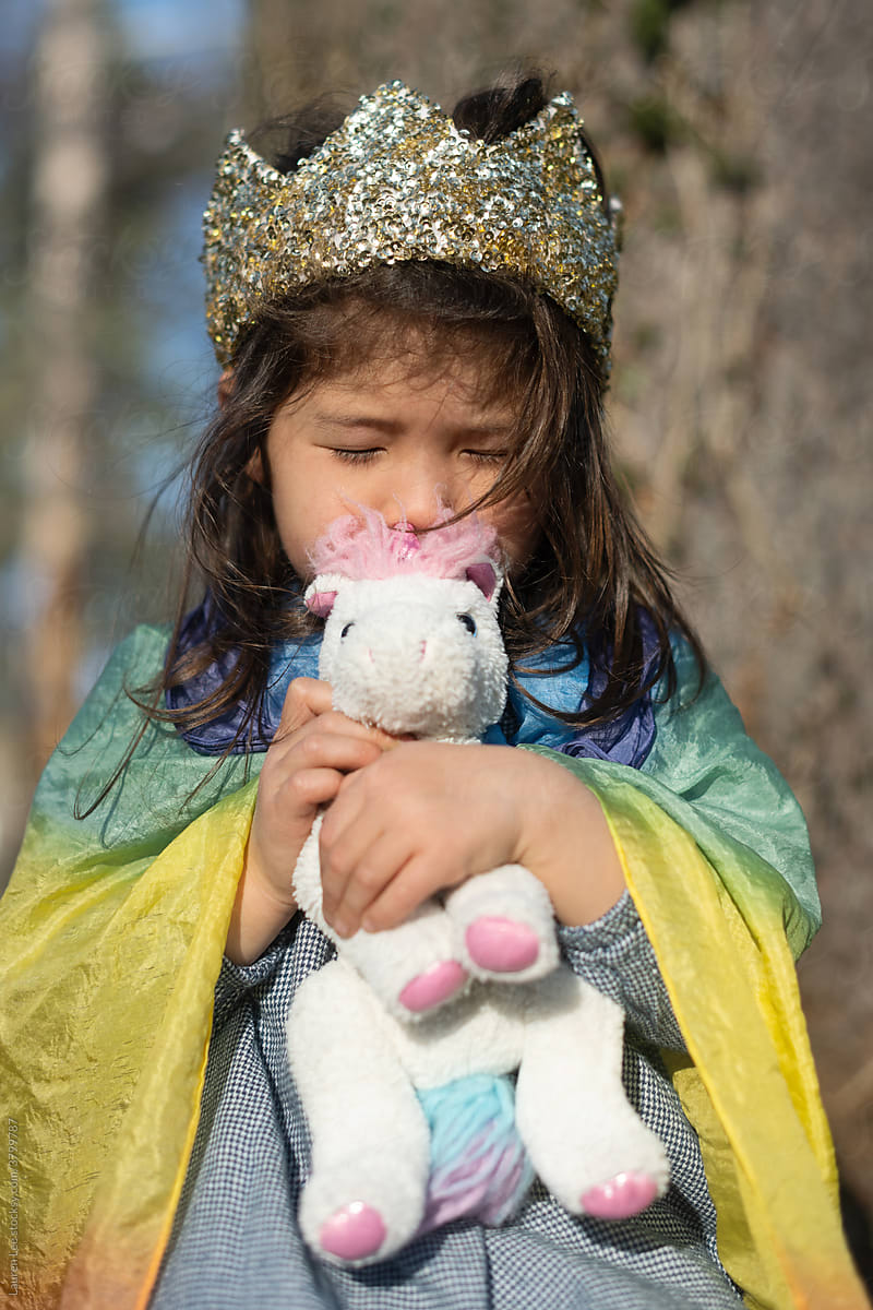 Little girl hugging stuffed animal