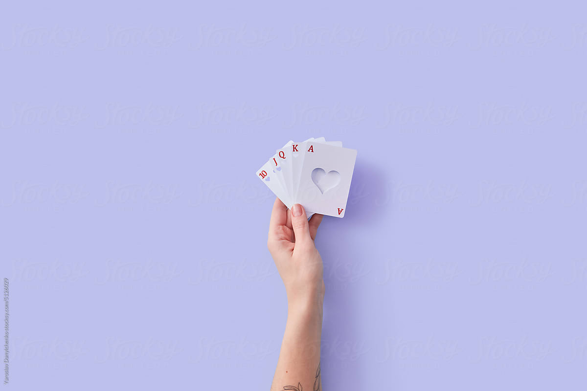 Cards with heart-shaped opening in female hand.