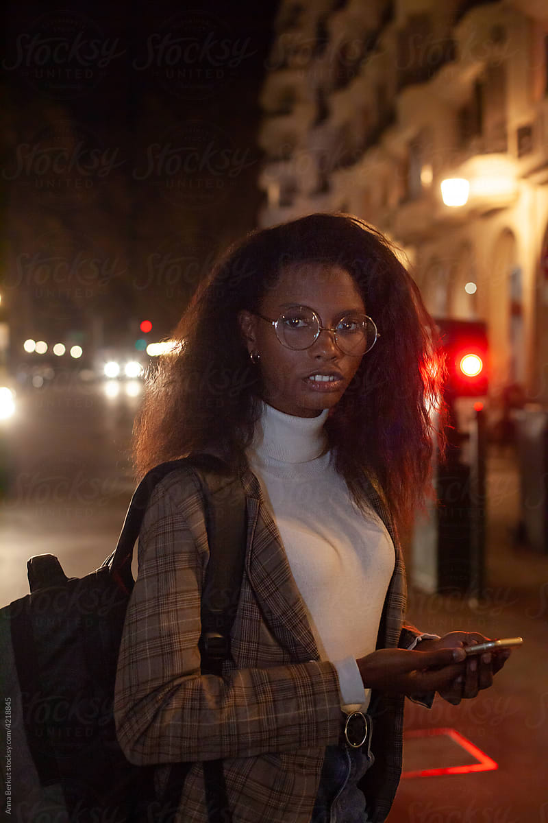 night portrait, black business woman looking at camera